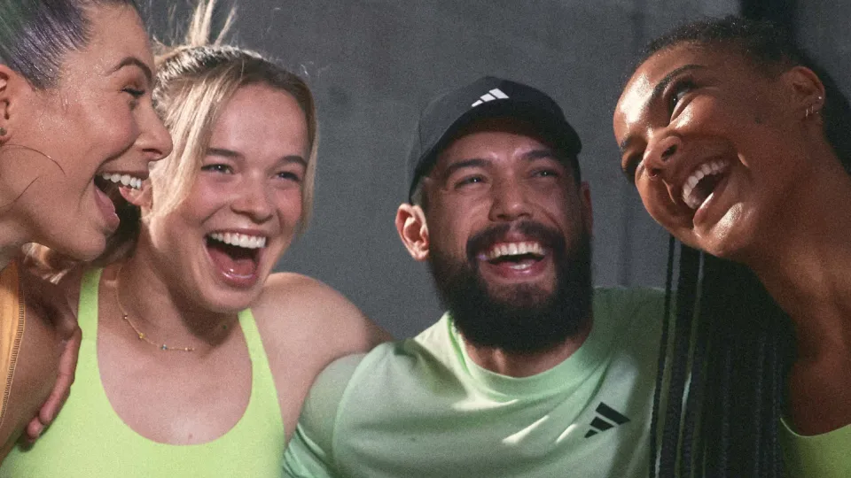 Four friends celebrating during a group workout.
